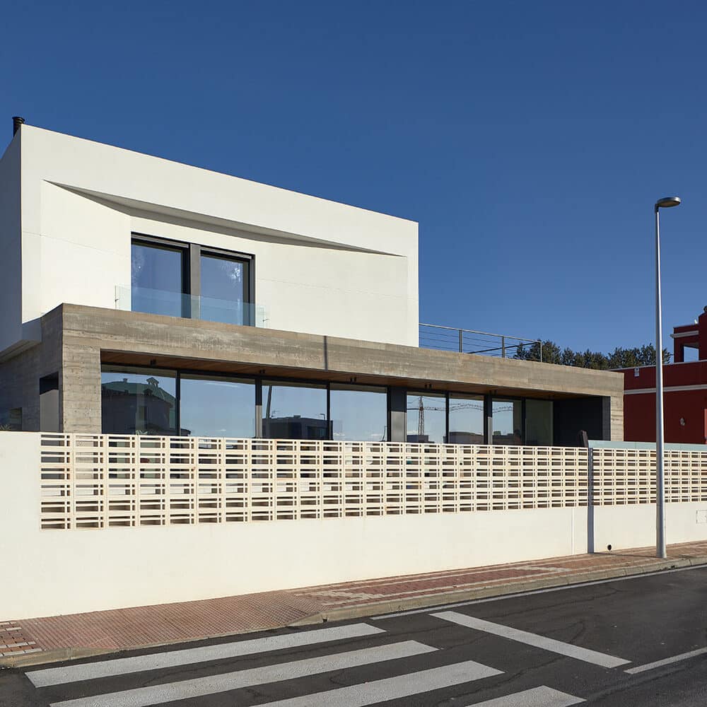 Fachada de casa moderna con celosía de gres natural en el muro exterior